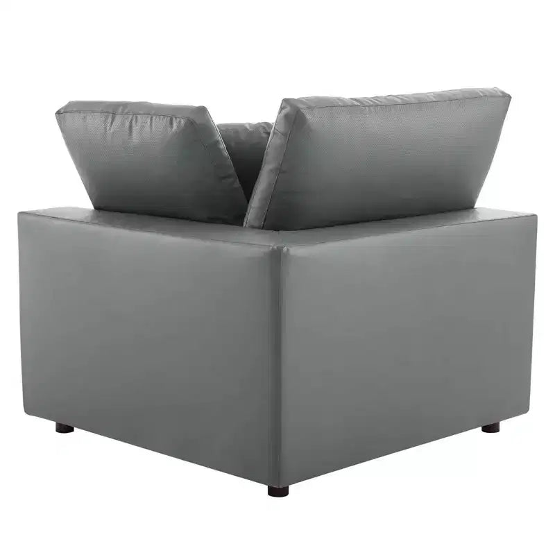 Fauteuil d'angle rembourré en similicuir garni de duvet