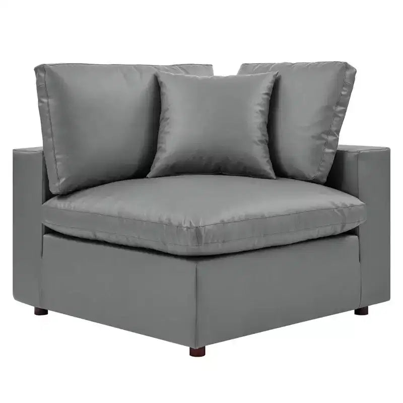 Fauteuil d'angle rembourré en similicuir garni de duvet